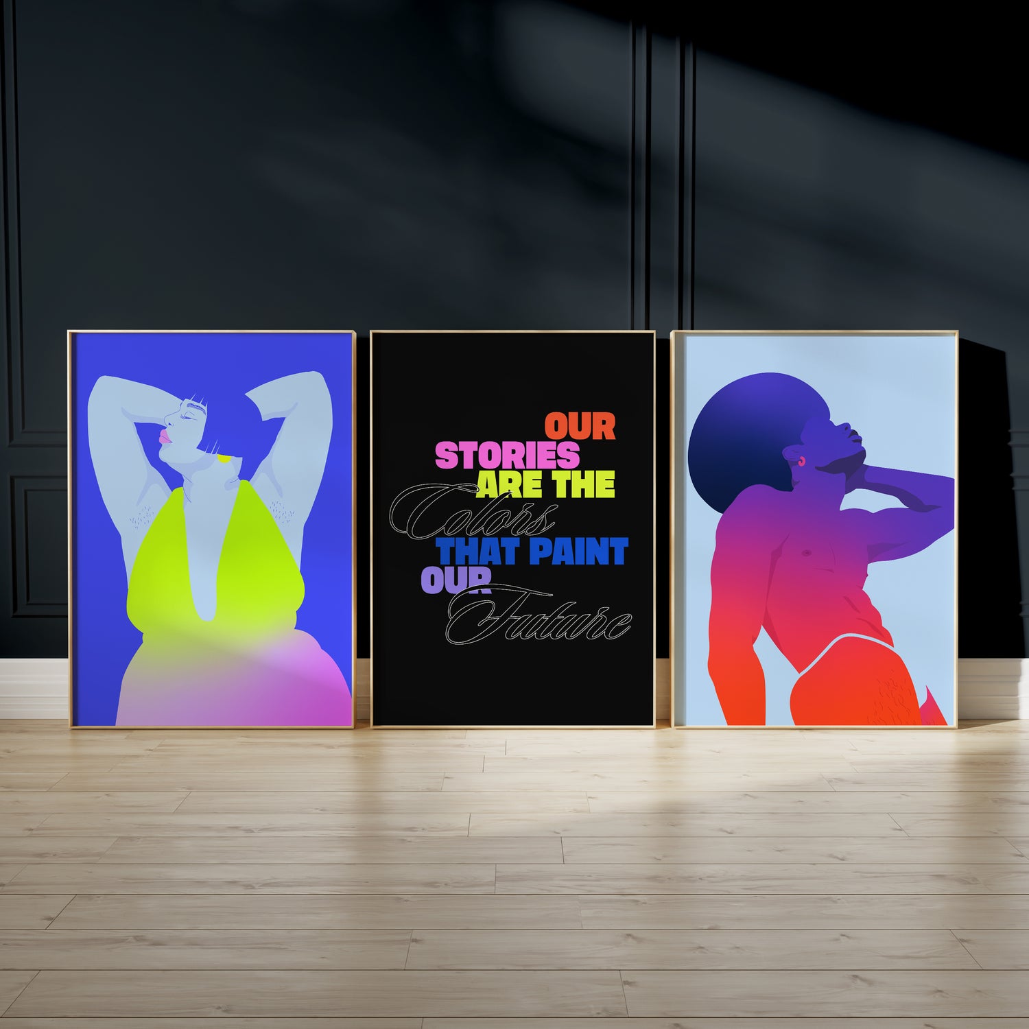 Trio of Partner art posters sit in frames on the floor rest against a dark wall.